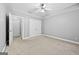 Spacious bedroom featuring a trey ceiling, ceiling fan and neutral carpet at 1721 Telfair Chase Way, Lawrenceville, GA 30043