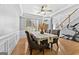 Open dining room showcases hardwood floors, a table setting, and access to other living areas at 1721 Telfair Chase Way, Lawrenceville, GA 30043