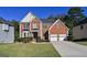 Beautiful two-story brick home with a well-manicured lawn and two car garage at 1721 Telfair Chase Way, Lawrenceville, GA 30043