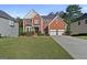 Charming two-story brick home with manicured lawn and attached two-car garage at 1721 Telfair Chase Way, Lawrenceville, GA 30043