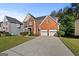 Attractive brick two-story home with a well-kept lawn and a two-car garage at 1721 Telfair Chase Way, Lawrenceville, GA 30043
