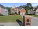 Inviting two-story brick home with lush lawn and attached two-car garage at 1721 Telfair Chase Way, Lawrenceville, GA 30043