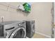 Laundry room featuring full size washer and dryer with wire rack storage at 1721 Telfair Chase Way, Lawrenceville, GA 30043