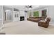 Comfortable living room featuring a fireplace, built-in shelving, and multiple windows at 1721 Telfair Chase Way, Lawrenceville, GA 30043
