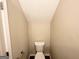 Cozy powder room features a white toilet, neutral walls and limited space at 371 Coral Cir, Mcdonough, GA 30253
