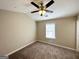 Bedroom with neutral walls, carpet and ceiling fan; natural light streams through the window at 371 Coral Cir, Mcdonough, GA 30253