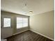 Neutral toned bedroom with laminate flooring, window and door to the exterior at 371 Coral Cir, Mcdonough, GA 30253