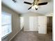 A bright bedroom featuring neutral paint, carpet, a ceiling fan, and closet at 371 Coral Cir, Mcdonough, GA 30253