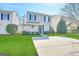 Charming two-story home with a well-maintained lawn and concrete driveway on a sunny day at 371 Coral Cir, Mcdonough, GA 30253