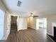 Spacious living area featuring hard surface floors, staircase, and ceiling fan at 371 Coral Cir, Mcdonough, GA 30253