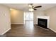 Open living room with fireplace, ceiling fan, and hard surface flooring throughout at 371 Coral Cir, Mcdonough, GA 30253