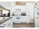 Functional kitchen with white cabinets, granite countertops, and essential appliances at 2636 General Lee Ct, Buford, GA 30519