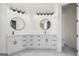 Modern bathroom features dual vanities with matte black hardware, round mirrors, and stylish light fixtures at 5265 Brookhollow Dr, Douglasville, GA 30135
