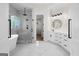A luxurious bathroom features a soaking tub, walk-in shower, double vanity, and marble tiling at 5265 Brookhollow Dr, Douglasville, GA 30135