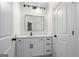 Bright bathroom with white vanity, black hardware, and modern mirror at 5265 Brookhollow Dr, Douglasville, GA 30135