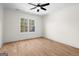 Bright bedroom with hardwood floors, ceiling fan, and natural light from a large window at 5265 Brookhollow Dr, Douglasville, GA 30135