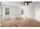 Spacious bedroom with hardwood floors, ceiling fan, and natural light from two large windows at 5265 Brookhollow Dr, Douglasville, GA 30135