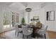 Elegant dining room featuring a modern chandelier, statement art, and a large window at 5265 Brookhollow Dr, Douglasville, GA 30135