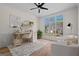 Modern home office setup with desk, chair, and decor accents complemented by natural light from the large window at 5265 Brookhollow Dr, Douglasville, GA 30135