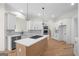 Modern kitchen featuring white cabinets, stainless steel appliances, a large island, and marble backsplash at 5265 Brookhollow Dr, Douglasville, GA 30135