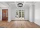 Spacious room with hardwood floors, white trim, and large windows bringing in natural light at 5265 Brookhollow Dr, Douglasville, GA 30135