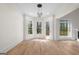 Bright living area with hardwood floors, recessed lights, large windows, and access to the outdoor deck at 5265 Brookhollow Dr, Douglasville, GA 30135