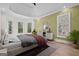 Stylishly furnished primary bedroom with tray ceiling, custom accent wall, and deck access at 5265 Brookhollow Dr, Douglasville, GA 30135