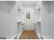 A large walk-in closet features custom shelving and hanging space, with a window for natural light at 5265 Brookhollow Dr, Douglasville, GA 30135