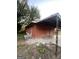 Side view of a boarded up red brick home with an awning at 1827 Thomasville Se Dr, Atlanta, GA 30315