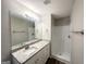 Bright bathroom features a granite-topped vanity with white cabinets and a walk-in shower at 2940 Highland Hill Pkwy, Douglasville, GA 30135