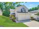Charming two-story home with manicured lawn, lush landscaping, and two-car garage at 2940 Highland Hill Pkwy, Douglasville, GA 30135
