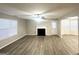 Bright living room with hardwood flooring, fireplace, ceiling fan, and large windows at 2940 Highland Hill Pkwy, Douglasville, GA 30135