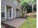 View of a backyard featuring a concrete patio and a well-maintained lawn with garden beds at 5860 Fairway View Dr, Suwanee, GA 30024