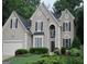 Charming two-story home featuring traditional architectural details and manicured landscaping at 5860 Fairway View Dr, Suwanee, GA 30024