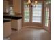 Eat-in kitchen featuring white cabinets, black countertops, and a view of the backyard at 5860 Fairway View Dr, Suwanee, GA 30024