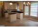 Bright kitchen with white cabinets, black countertops, and a center island at 5860 Fairway View Dr, Suwanee, GA 30024