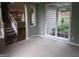 Inviting living room with a staircase and large windows providing natural light and outdoor views at 5860 Fairway View Dr, Suwanee, GA 30024