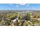 Aerial view of a brick home and mature tree canopy with a cityscape in the background at 619 E Pelham Ne Rd, Atlanta, GA 30324