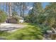 Well-maintained backyard featuring a paved area, a detached garage, and vibrant greenery at 619 E Pelham Ne Rd, Atlanta, GA 30324