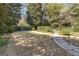 Expansive backyard with a stone pathway, mature trees, and lush landscaping at 619 E Pelham Ne Rd, Atlanta, GA 30324