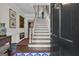 Welcoming foyer featuring hardwood floors, elegant staircase, and tasteful artwork at 619 E Pelham Ne Rd, Atlanta, GA 30324