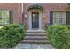 Close-up of the front entrance, showcasing a brick facade, elegant door, and meticulously maintained landscaping at 619 E Pelham Ne Rd, Atlanta, GA 30324