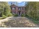 Charming brick home with black shutters, mature landscaping, and a stone pathway to the front entrance at 619 E Pelham Ne Rd, Atlanta, GA 30324