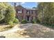 Charming brick home with black shutters, mature landscaping, and a stone pathway to the front entrance at 619 E Pelham Ne Rd, Atlanta, GA 30324