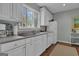 Functional kitchen featuring white cabinets and neutral countertops, ready for updates at 619 E Pelham Ne Rd, Atlanta, GA 30324