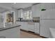 Bright kitchen with white cabinets, neutral countertops, and stainless steel appliances at 619 E Pelham Ne Rd, Atlanta, GA 30324