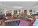 Spacious living room with unique star-patterned red carpet, cozy seating, and elegant decor at 619 E Pelham Ne Rd, Atlanta, GA 30324