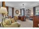 Cozy living room with ample seating, decorative mirror, and neutral carpet at 619 E Pelham Ne Rd, Atlanta, GA 30324