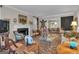 Open living room with fireplace, vintage furniture and open to dining room at 619 E Pelham Ne Rd, Atlanta, GA 30324