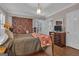 Comfortable bedroom with a brass bed frame, shutters and natural light at 619 E Pelham Ne Rd, Atlanta, GA 30324